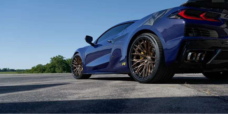 Close-up of E5 forged wheel on C8 E-Ray — brake caliper and spoke detail