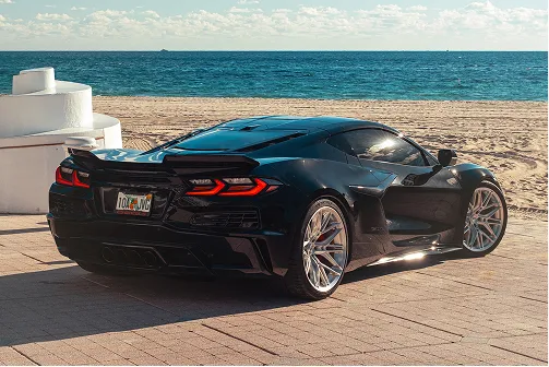 C8 E-Ray Corvette with E5 Sonoma wheels at beach — rear quarter view